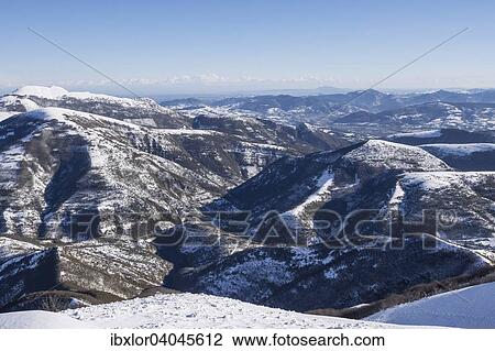 Stock Image - "View of the Appenines from Mount Motette, blue sky with clouds, Umbria, Italy, Europe". Fotosearch