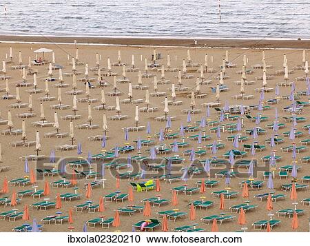 "View of the beach with closed parasols and sun loungers, Lignano Sabbiadoro in the evening, Udine, Adriatic Coast, Italy, Europe" View Large Photo Image Stock Image - "View of the beach with closed parasols and sun loungers, Lignano Sabbiadoro in the evening, Udine, Adriatic Coast, Italy, Europe". Fotosearch