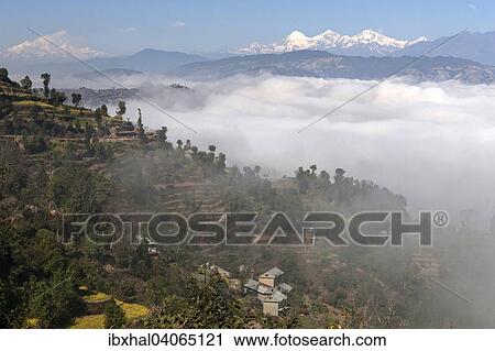 "View of the countryside, rural houses, terraced fields and mountains of the Himalayas, fog in the valley, near Dhulikel, Nepal, Asia" View Large Photo Image Stock Image - "View of the countryside, rural houses, terraced fields and mountains of the Himalayas, fog in the valley, near Dhulikel, Nepal, Asia". Fotosearch