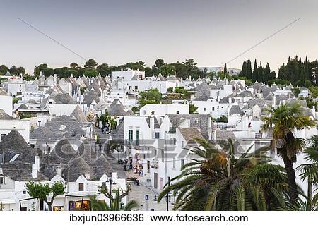 "View of the Rione Monti district at dusk, trulli, traditional round houses, trullo settlement, Alberobello, Valle d'Itria, Trulli Valley, Apulia, Italy, Europe" View Large Photo Image Stock Photograph - "View of the Rione Monti district at dusk, trulli, traditional round houses, trullo settlement, Alberobello, Valle d'Itria, Trulli Valley, Apulia, Italy, Europe". Fotosearch