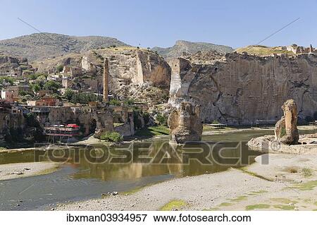 Stock Photo - "View of the town with the minaret of the El Rizk Mosque, pillars of the bridge built by the Ortocides, Hasankeyf, Tigris River, Batman Province, Southeastern Anatolia Region, Anatolia, Turkey, Asia". Fotosearch