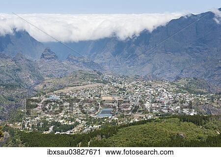 Stock Image - "View over the city and the ForÈ‡t du Grand Matarum, wall of clouds, Cirque de Cilaos, Cilaos, Reunion". Fotosearch