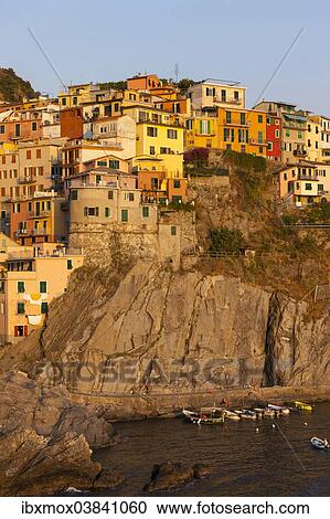 Stock Image - "Village with colourful houses by the sea, Manarola, Cinque Terre, UNESCO World Heritage Site, Province of La Spezia, Liguria, Italy, Europe". Fotosearch