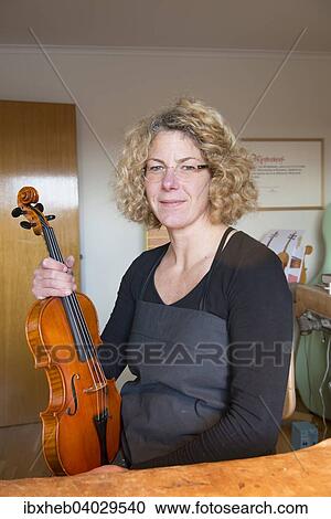 Violin maker with the finished violin View Large Photo Image Stock Image - Violin maker with the finished violin. Fotosearch