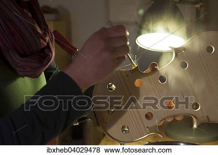 "Violin making, attaching the wooden tun ring" View Large Photo Image Stock Photo - "Violin making, attaching the wooden tun ring". Fotosearch