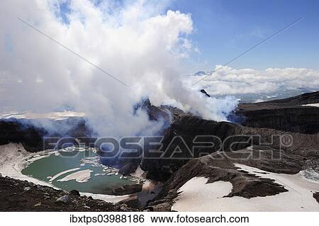 Stock Photograph - "Volcanic crater with crater lake and a hot water vapour cloud, Gorely volcano, Kamchatka Peninsula, Russia, Europe". Fotosearch
