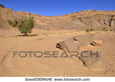 "Volcanic landscape of the upper Ouksem crater, Menzaz, Tamanrasset Province, Algeria, Africa" View Large Photo Image Stock Photograph - "Volcanic landscape of the upper Ouksem crater, Menzaz, Tamanrasset Province, Algeria, Africa". Fotosearch