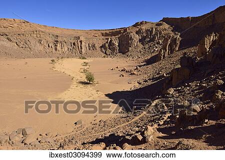 "Volcanic landscape of upper Ouksem crater, Menzaz, Tamanrasset Province, Algeria, Africa" View Large Photo Image Stock Photo - "Volcanic landscape of upper Ouksem crater, Menzaz, Tamanrasset Province, Algeria, Africa". Fotosearch