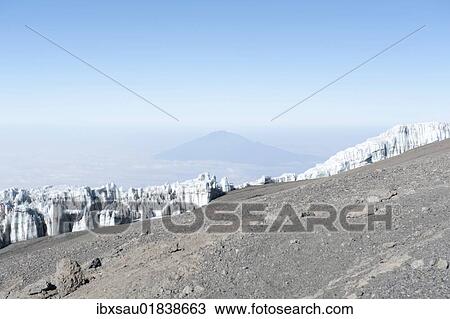 Stock Image - "Wall of ice, Kersten Glacier on the crater rim of Kibo, summit of Uhuru Peak, extinct volcano, with Mount Meru in the distance, Kilimanjaro National Park, Marangu Route, Tanzania, East Africa, Africa". Fotosearch