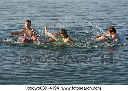 "Water fight, children playing on floating tyres in the sea, Mediterranean, near Fano, Marche, Adriatic, Italy, Europe" View Large Photo Image Picture - "Water fight, children playing on floating tyres in the sea, Mediterranean, near Fano, Marche, Adriatic, Italy, Europe". Fotosearch