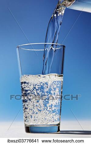 Water is being poured into a glass View Large Photo Image Stock Image - Water is being poured into a glass. Fotosearch