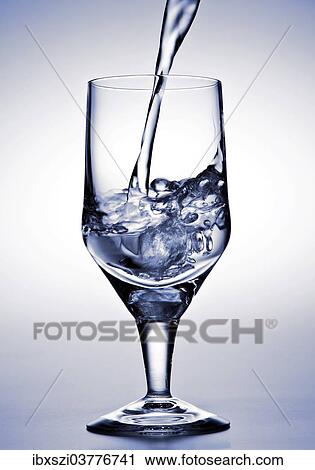 Water is being poured into a glass View Large Photo Image Stock Image - Water is being poured into a glass. Fotosearch
