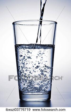 Stock Photo - Water is being poured into a glass. Fotosearch