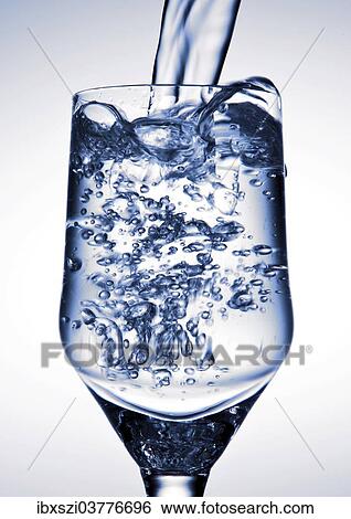 Water is being poured into a glass View Large Photo Image Stock Photograph - Water is being poured into a glass. Fotosearch