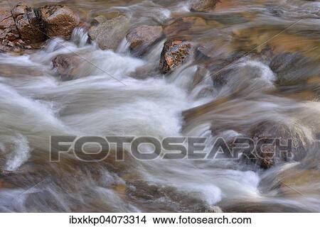 Picture - "Water running over rocks in a brook in autumn, Ilse mountain brook, Ilsenburg, Saxony-Anhalt, Germany, Europe". Fotosearch
