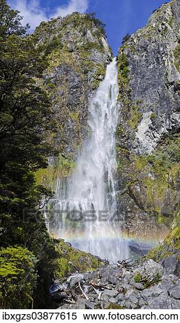 Stock Photography - "Waterfall with a rainbow, Devil's Punchbowl Falls, Arthur's Pass, South Island, New Zealand, Oceania". Fotosearch