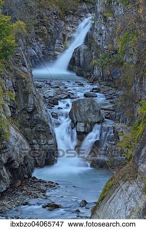 Stock Photo - "Waterfalls of the Grand Eyvia in autumn, Gran Paradiso National Park, Valle di Cogne, Piedmont, Italy, Europe". Fotosearch