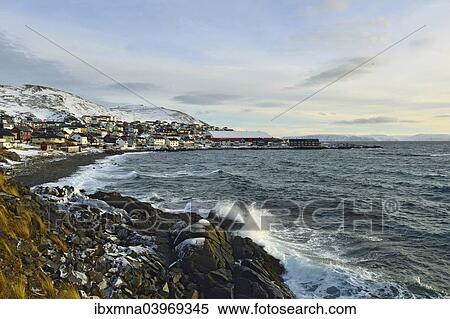 "Waves in a rocky bay, buildings of the Honningsvag settlement at the back, Mageroya island, Finnmark County, Norway, Europe" View Large Photo Image Stock Photography - "Waves in a rocky bay, buildings of the Honningsvag settlement at the back, Mageroya island, Finnmark County, Norway, Europe". Fotosearch