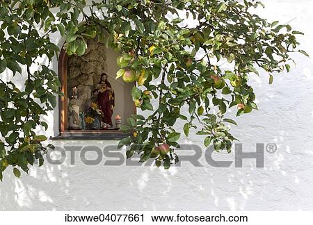 Stock Image - "Wayside chapel, window, apple tree, Mondsee, Salzkammergut, Upper Austria, Austria, Europe". Fotosearch