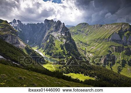 Stock Image - "Weather mood, light mood on Faelensee lake between Mt. Hundsteingrat and Mt. Roslen-Saxer First in the Alpsteingebirge mountains, Bruelisau, Canton Appenzell Innerrhoden, Switzerland, Europe". Fotosearch