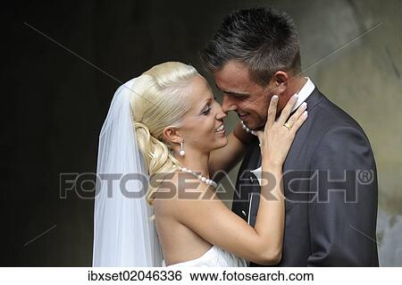Stock Photograph - "Wedding, bride and groom smiling at each other". Fotosearch