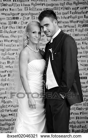 "Wedding, bride and groom standing in front of a wall with letters" View Large Photo Image Stock Image - "Wedding, bride and groom standing in front of a wall with letters". Fotosearch