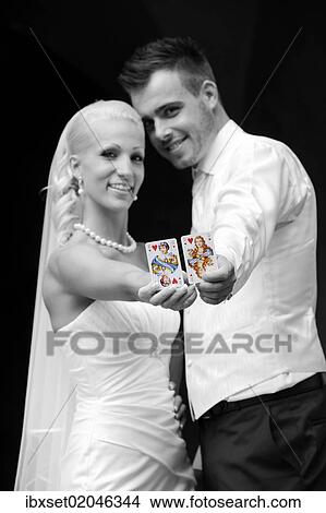 "Wedding, bride and groom with playing cards, queen and jack of hearts" View Large Photo Image Picture - "Wedding, bride and groom with playing cards, queen and jack of hearts". Fotosearch