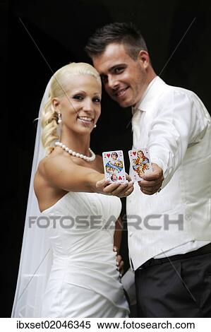 Stock Photography - "Wedding, bride and groom with playing cards, queen and jack of hearts". Fotosearch