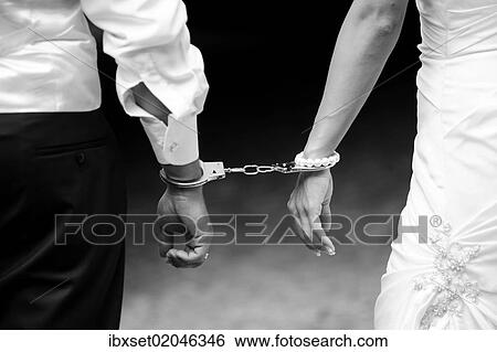 Stock Photograph - "Wedding, bride and groom with handcuffs". Fotosearch