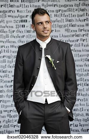 Stock Photo - "Wedding, groom standing in front of a wall with letters". Fotosearch