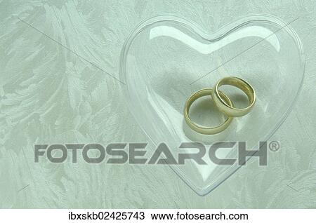 Wedding rings in a transparent heart View Large Photo Image Stock Image - Wedding rings in a transparent heart. Fotosearch