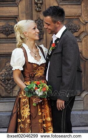 "Wedding, smiling bride and groom in traditional dress looking at each other" View Large Photo Image Stock Photo - "Wedding, smiling bride and groom in traditional dress looking at each other". Fotosearch