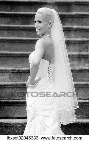 "Wedding, smiling bride standing on a staircase" View Large Photo Image Stock Image - "Wedding, smiling bride standing on a staircase". Fotosearch