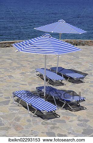 "White-blue striped sunloungers and parasols, Crete, Greece, Europe, PublicGround, Europe" View Large Photo Image Stock Image - "White-blue striped sunloungers and parasols, Crete, Greece, Europe, PublicGround, Europe". Fotosearch