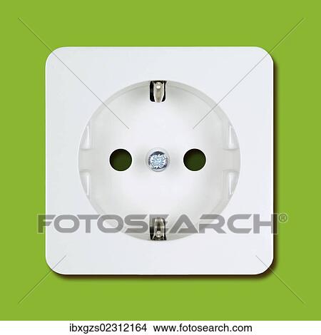 Picture - White electric socket on a green wall. Fotosearch