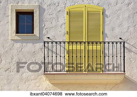 Stock Photo - "White house facade with a balcony, a yellow balcony door and a small window, Villaricos, Cuevas del Almanzora, Almeria province, Andalucia, Spain, Europe". Fotosearch