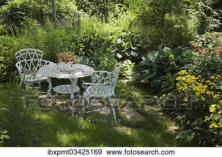 "White metal garden table and chairs in a residential backyard, Quebec City, Quebec Province, Canada, North America" View Large Photo Image Stock Photo - "White metal garden table and chairs in a residential backyard, Quebec City, Quebec Province, Canada, North America". Fotosearch
