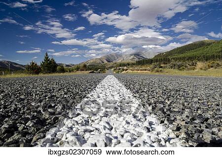 "White road markings on a road with coarse asphalt, worm's eye view, Arthur's Pass Road, South Island, New Zealand, Oceania" View Large Photo Image Stock Photo - "White road markings on a road with coarse asphalt, worm's eye view, Arthur's Pass Road, South Island, New Zealand, Oceania". Fotosearch