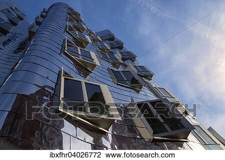 Stock Image - "Windows on the port side, Neuer Zollhof or Gehry buildings in the Media Harbour, Dusseldorf, North Rhine-Westphalia, Germany, Europe". Fotosearch