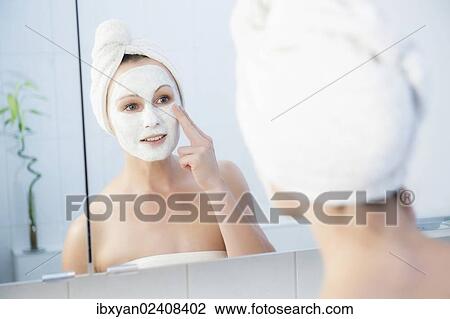 "Woman, 30+, in the bathroom applying a facial mask" View Large Photo Image Stock Image - "Woman, 30+, in the bathroom applying a facial mask". Fotosearch
