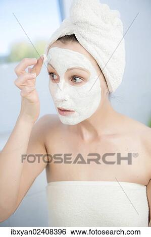 "Woman, 30+, in the bathroom applying a facial mask" View Large Photo Image Stock Photograph - "Woman, 30+, in the bathroom applying a facial mask". Fotosearch