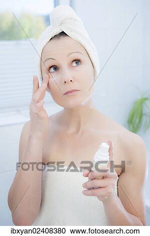 "Woman, 30+, in the bathroom applying facial care" View Large Photo Image Stock Image - "Woman, 30+, in the bathroom applying facial care". Fotosearch