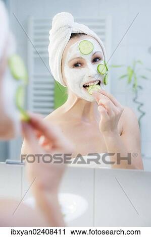 "Woman, 30+, in the bathroom applying cucumber slices to a facial mask" View Large Photo Image Stock Image - "Woman, 30+, in the bathroom applying cucumber slices to a facial mask". Fotosearch