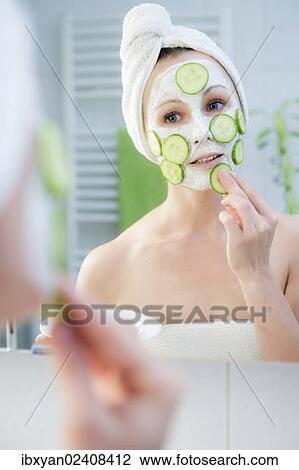 "Woman, 30+, in the bathroom applying cucumber slices to a facial mask" View Large Photo Image Stock Image - "Woman, 30+, in the bathroom applying cucumber slices to a facial mask". Fotosearch