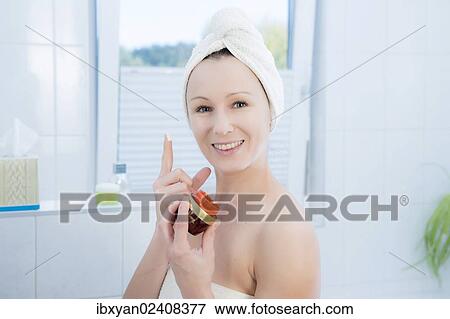 "Woman, 30+, in the bathroom applying facial care" View Large Photo Image Stock Photo - "Woman, 30+, in the bathroom applying facial care". Fotosearch