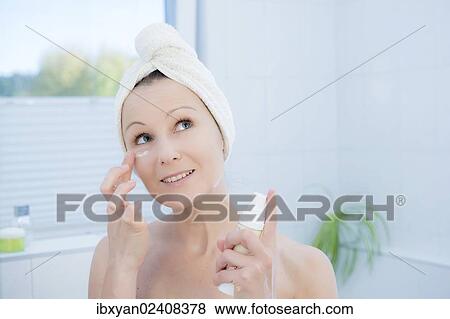 "Woman, 30+, in the bathroom applying facial care" View Large Photo Image Stock Photo - "Woman, 30+, in the bathroom applying facial care". Fotosearch