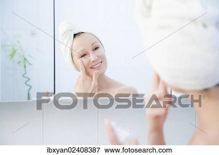 "Woman, 30+, in the bathroom applying facial care" View Large Photo Image Stock Photo - "Woman, 30+, in the bathroom applying facial care". Fotosearch
