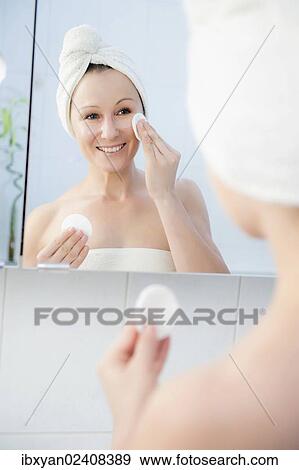 "Woman, 30+, in the bathroom applying facial care" View Large Photo Image Stock Photo - "Woman, 30+, in the bathroom applying facial care". Fotosearch
