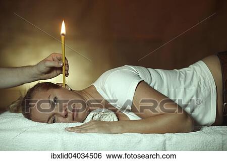 "Woman, 44 years, is being treated with an ear candle" View Large Photo Image Stock Photograph - "Woman, 44 years, is being treated with an ear candle". Fotosearch