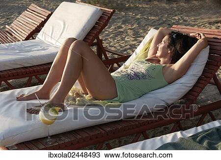"Woman, 45 years, in a beach outfit, relaxing on a sun lounger with a pina colada cocktail, Playa Samara, Nicoya Peninsula, Costa Rica, Central America, North America" View Large Photo Image Stock Image - "Woman, 45 years, in a beach outfit, relaxing on a sun lounger with a pina colada cocktail, Playa Samara, Nicoya Peninsula, Costa Rica, Central America, North America". Fotosearch